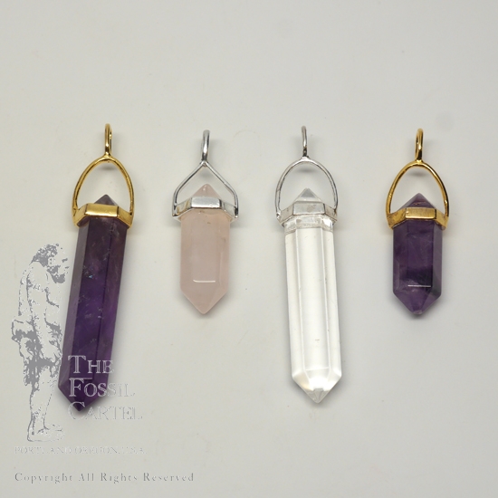 4 simple crystal-shaped pendants made from vogel cut quartz set in sterling silver or gold plated against a grey background.