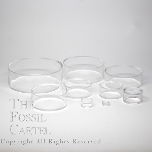 Clear acrylic sphere stands in multiple sizes against a grey background