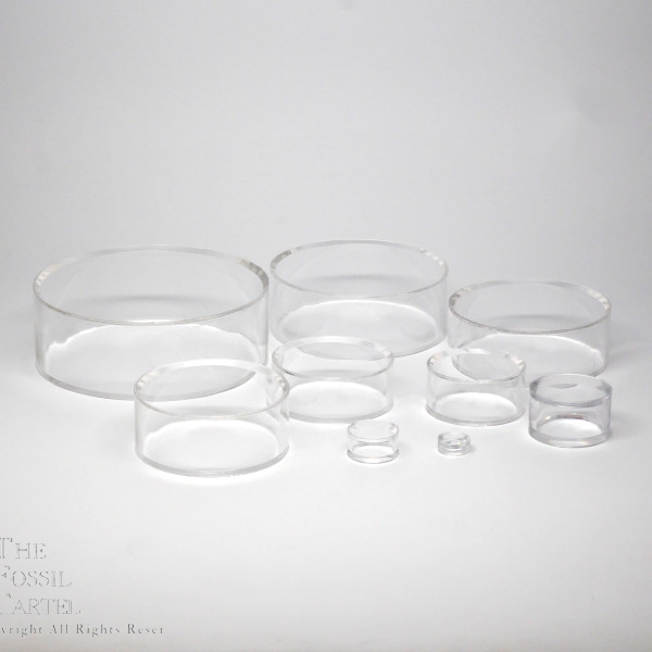 Clear acrylic sphere stands in multiple sizes against a grey background