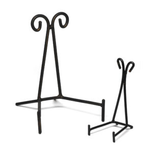 A pair of black wrought iron triangle stands against a white background