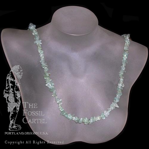 An aquamarine chip necklace against a black background