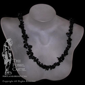 A tumbled onyx chip necklace against a black background