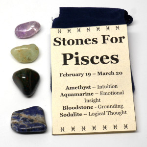 An astrological healing stone pouch for pisces featuring amethyst, aquamarine, bloodstone, and sodalite tumbled stones with a felt pouch against a white background