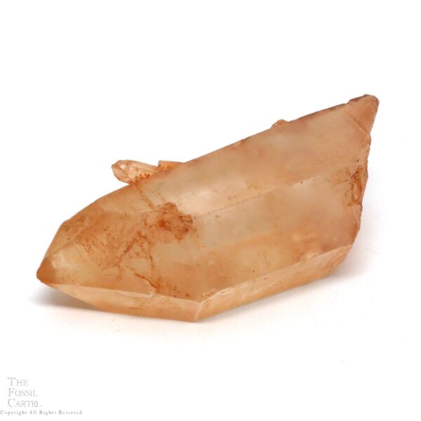 A clear quartz crystal with a rust-like coating due to iron and a tiny "sibling" crystal jutting out from its side.