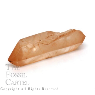 A clear quartz crystal with a rust-like coating due to iron and a notch in its side where another crystal once grew.