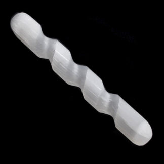 A polished and twisted selenite massage wand against a black background