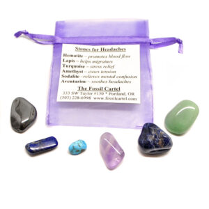 A healing pouch for headaches featuring tumbled hematite, lapis lazuli, turquoise, amethyst, sodalite, and aventurine with a purple organza pouch against a white background