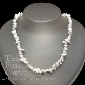 A necklace made of howlite chips against a black background