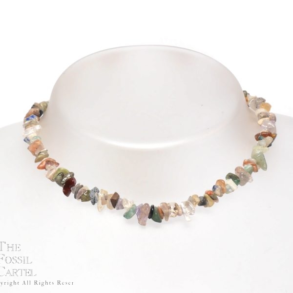 A necklace made of mixed stone chips against a grey background