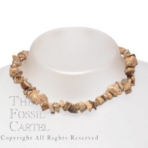 A necklace made of picture jasper chips against a grey background