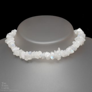 A necklace made of rainbow moonstone chips against a black background