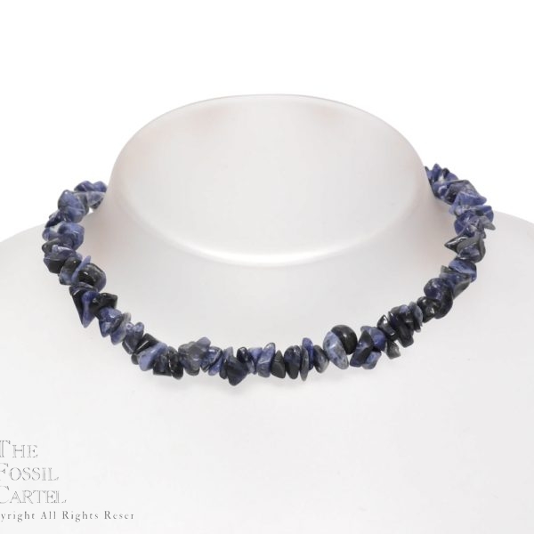 A stone chip necklace made of sodalite against a grey background