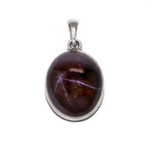 A star garnet sterling silver pendant against a white background