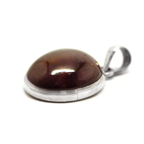A star garnet sterling silver pendant against a white background