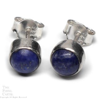 A simple set of sterling silver stud earrings set with round blue lapiz lazuli cabochons against a white background