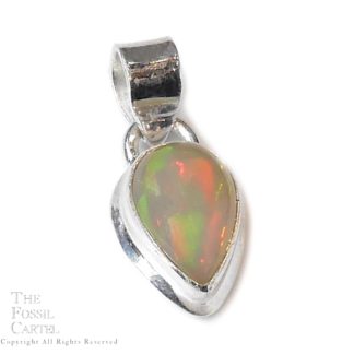 A translucent Ethiopian opal pear-shaped cabochon set in a sterling silver pendant against a white background