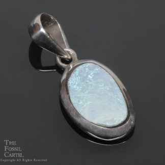 A mostly light blue Australian opal set in a sterling silver pendant against a black background