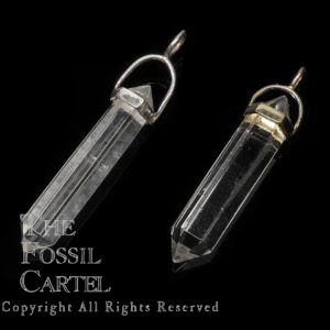 Two clear quartz crystal shaped pendants in sterling silver or gold plated against a black background
