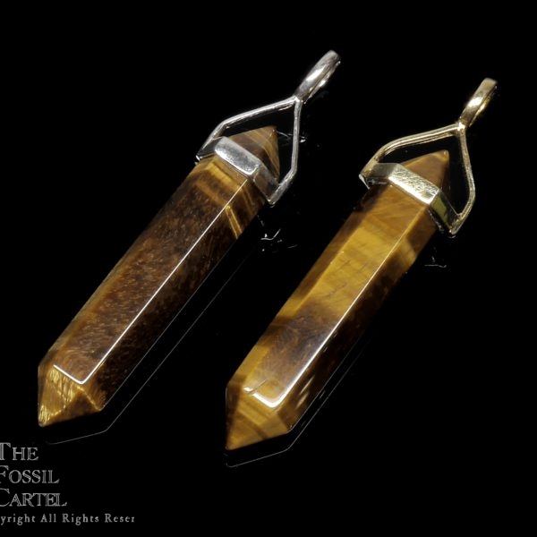 Two simple crystal shaped tiger's eye pendants set in sterling silver and gold plated against a black background