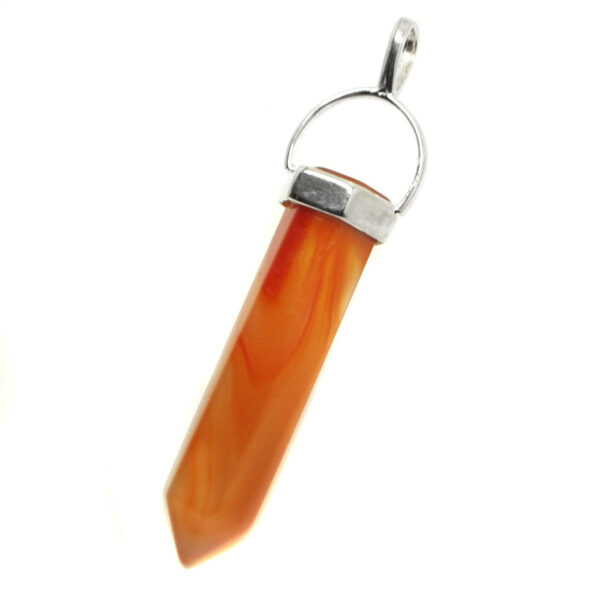 A piece of carnelian carved into a crystal and set in a sterling silver pendant against a white background