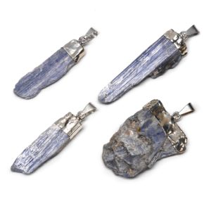 Blue kyanite crystal pendants set with a simple base metal cap and bail against a white background