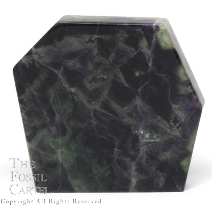 A slab of translucent rainbow fluorite cut and polished on all sides, against a white background