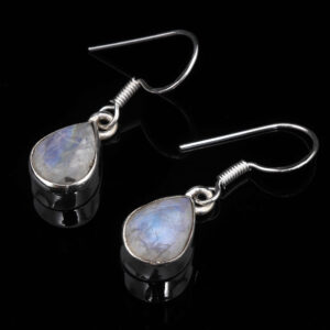 A pair of sterling silver rainbow moonstone teardrop dangle earrings against a black background