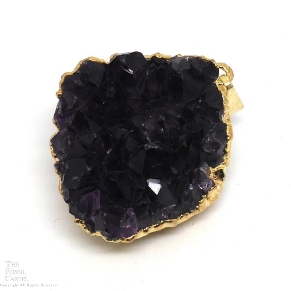 A small cluster of dark purple amethyst crystals with gold-colored electroplating affixed to a bail which it hangs from to be worn as a pendant
