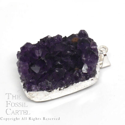 A small cluster of dark purple amethyst crystals with silver-colored electroplating affixed to a bail which it hangs from to be worn as a pendant