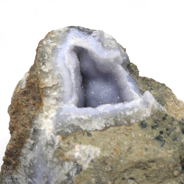 The largest opening of the blue chalcedony crystal cavity inside of this specimen, with druzy crystals coating a botryoidal formation inside and matrix outside.
