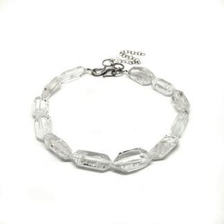 A beaded necklace of double terminated clear quartz crystal against a white background