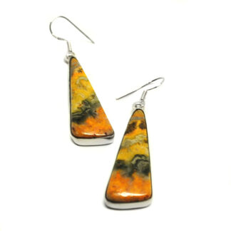 A pair of triangular bumblebee jasper cabochons set in sterling silver earrings against a white background