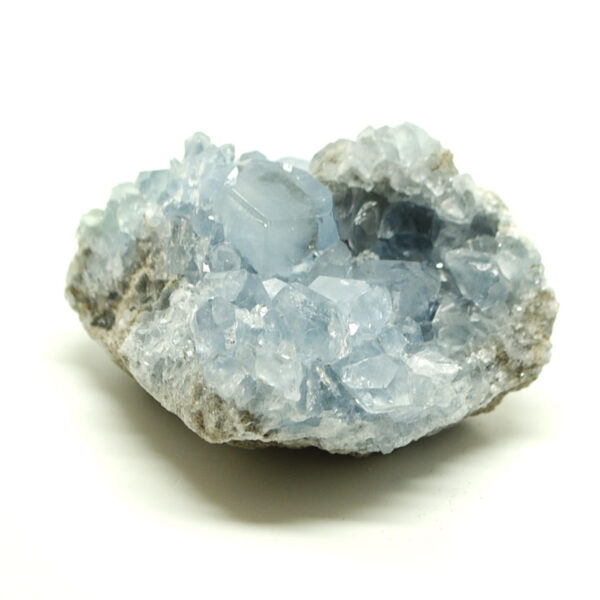 A gemmy blue celestite crystal cluster with well defined crystals against a white background
