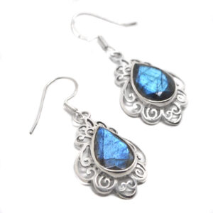 A pair of ornate sterling silver earrings with faceted teadrop labradorite cabochons against a white background