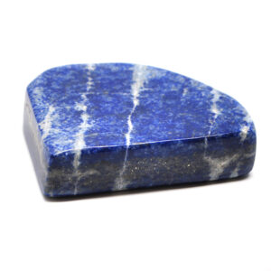 A freeform lapis lazuli carving against a white background