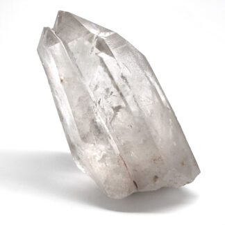 A clear quartz crystal against a white background
