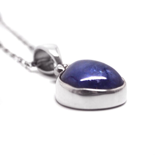 A sterling silver tanzanite pendant against a white background
