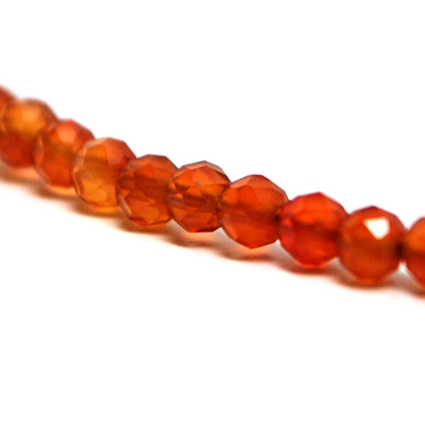 A carnelian micro-bead necklace with silver clasp against white background