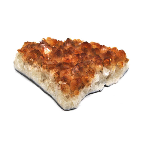 A citrine crystal cluster against a white background