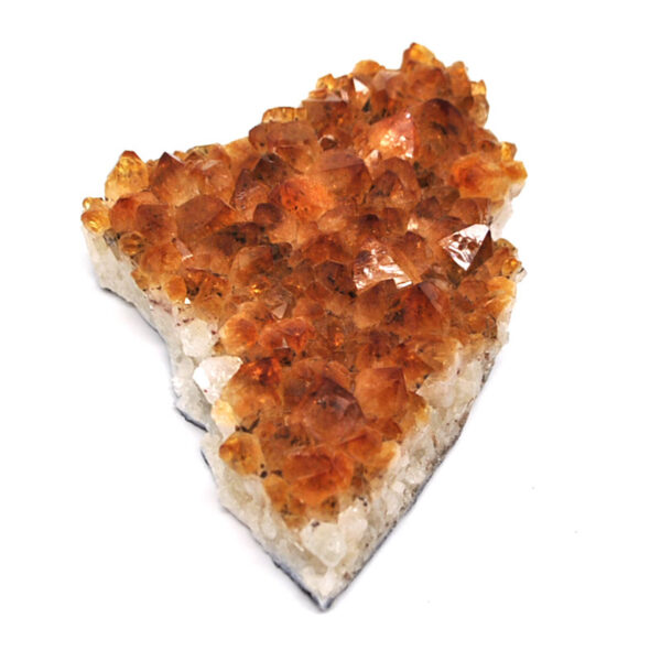 A citrine crystal cluster against a white background