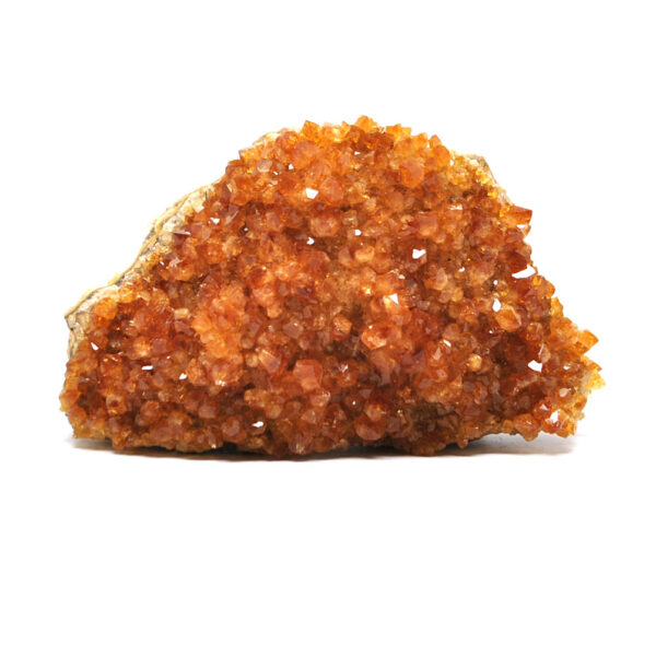 A citrine crystal cluster against a white background