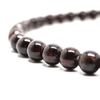 A beaded garnet necklace against a white background