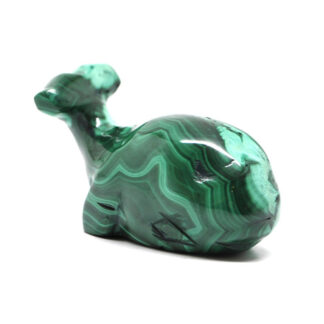 A green malachite whale carving against a white background