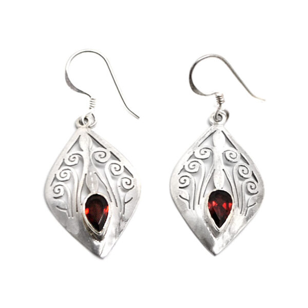 A pair of intricately designed sterling silver diamond-shaped earrings with faceted garnet gemstones against a white background
