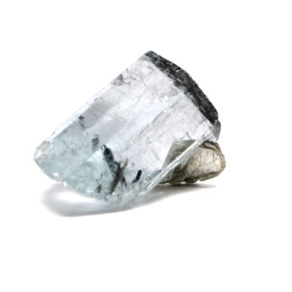 A transparent gemmy blue aquamarine crystal with mica inclusions against a white background