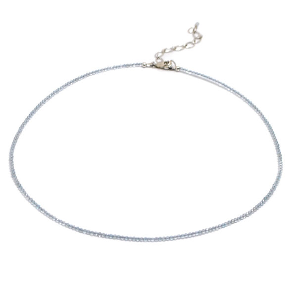A blue topaz microbead necklace against a white background