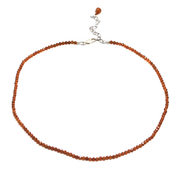 A hessonite garnet microbead necklace against a white background