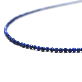 A lapis lazuli microbead necklace against a white background