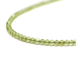 A peridot microbead necklace against a white background