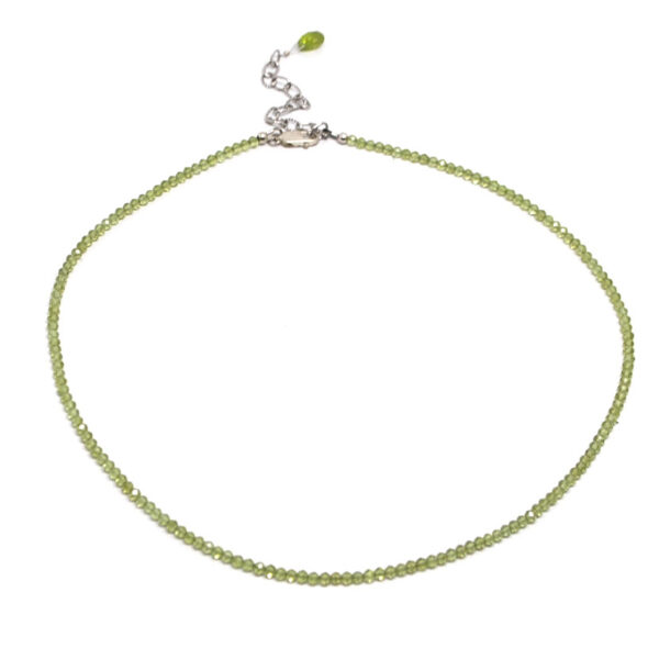 A peridot microbead necklace against a white background